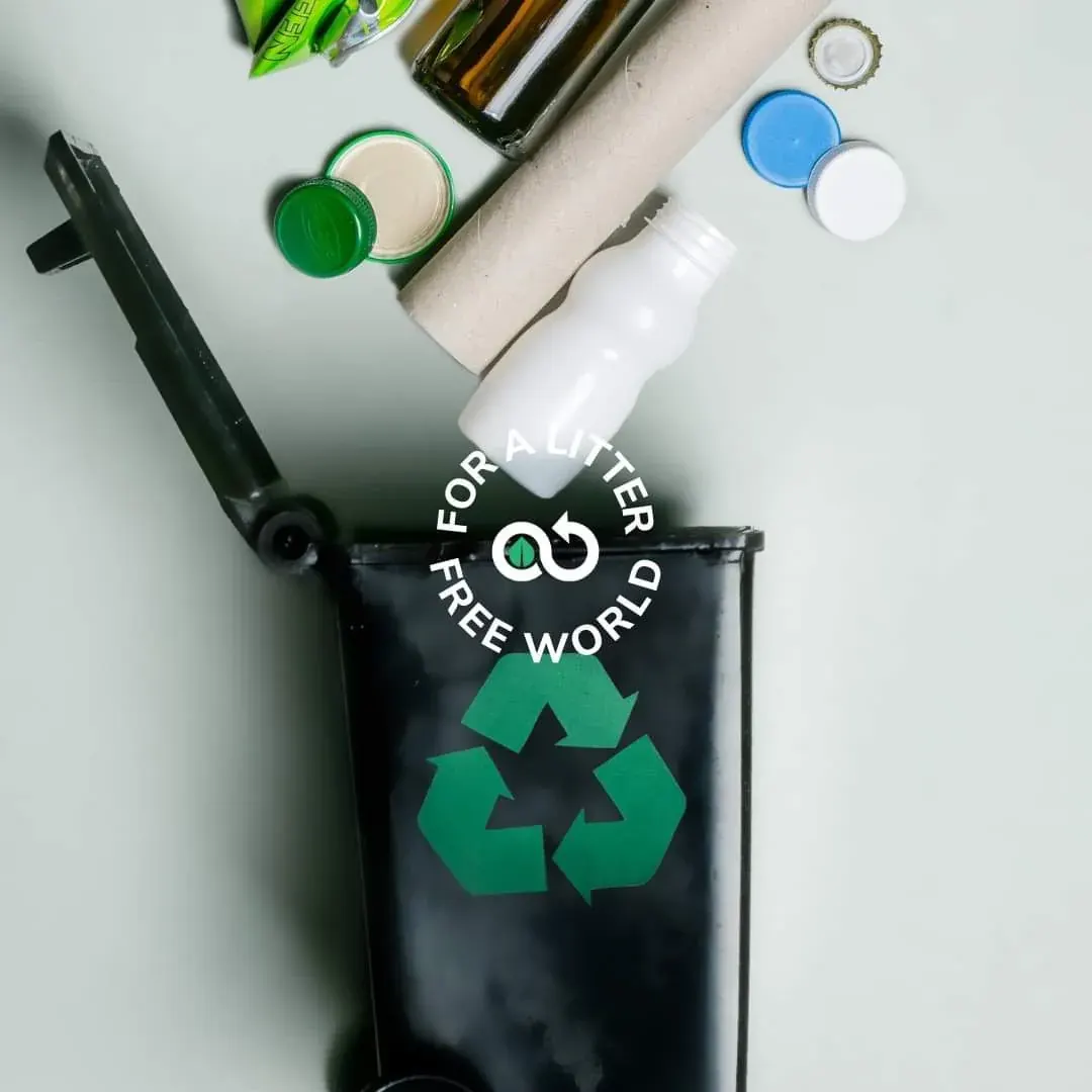 Recycling bin with sorted bottles, caps, and a cardboard tube for household recycling collection Recycling bin with sorted bottles, caps, and a cardboard tube for household recycling collection