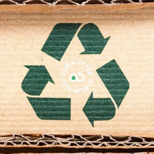 Cardboard box with a recycling symbol and sustainability text, used for recycling programme messaging Cardboard box with a recycling symbol and sustainability text, used for recycling programme messaging
